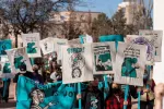 A group of educators holding protest signs
